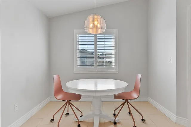 a view of a dining room with furniture and a chandelier