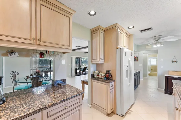a kitchen with stainless steel appliances granite countertop a stove microwave and cabinets
