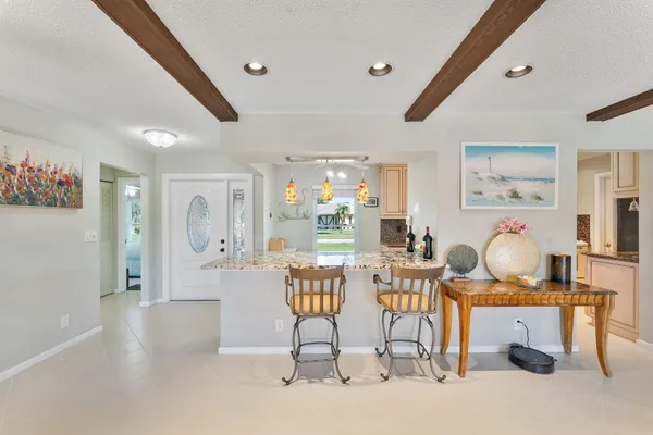a kitchen with stainless steel appliances kitchen island granite countertop a refrigerator and a stove
