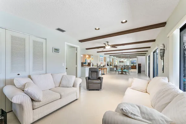 a spacious bedroom with a bed and ceiling fan