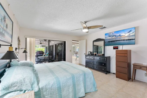 a bedroom with a bed and a refrigerator