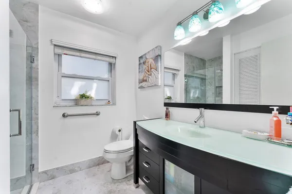 a bathroom with a sink toilet and shower