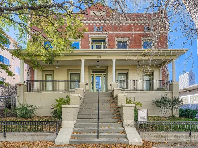 front view of a brick house with a small yard