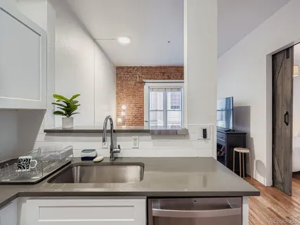 a kitchen with a sink and a refrigerator