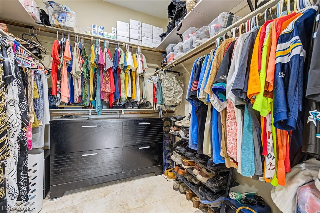 4914 East Beacon Ridge Drive Pahrump, NV 89061 - Photo 21 of 34 Organized clothing racks and ample storage space define this well-appointed walk-in closet.