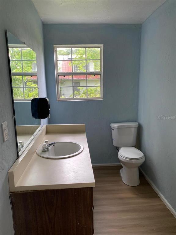 504 Southwest Fort King Street Ocala, FL 34471 - Photo 6 of 13 a bathroom with a toilet a sink and a window