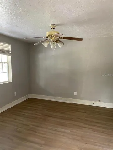 a view of room with window and ceiling fan