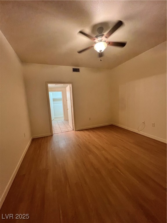 2152 Quarry Ridge Street, Unit 103 Las Vegas, NV 89117 - Photo 24 of 43 Empty room featuring light wood-style flooring, a textured ceiling, and a ceiling fan