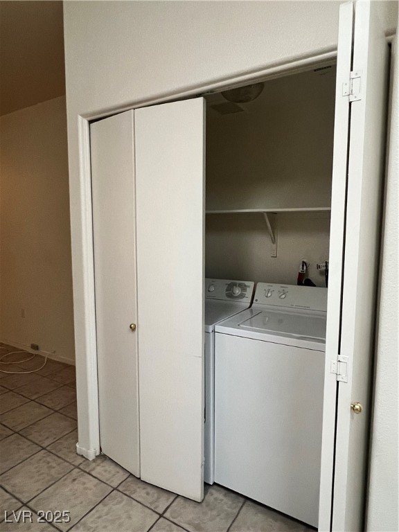 2152 Quarry Ridge Street, Unit 103 Las Vegas, NV 89117 - Photo 29 of 43 Laundry area with light tile patterned flooring and washing machine and clothes dryer