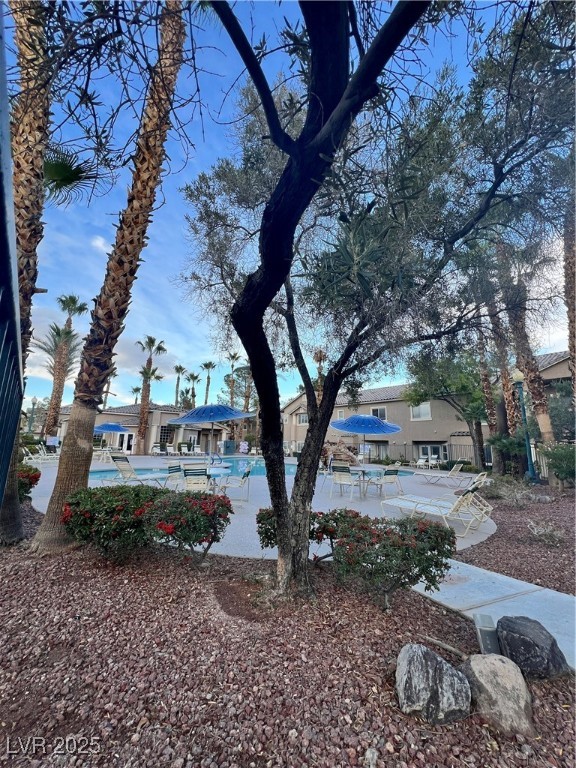 2152 Quarry Ridge Street, Unit 103 Las Vegas, NV 89117 - Photo 34 of 43 View of yard featuring a patio area, a community pool, and a residential view