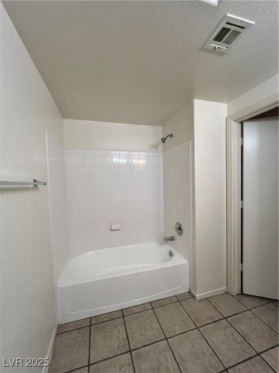 2152 Quarry Ridge Street, Unit 103 Las Vegas, NV 89117 - Photo 7 of 43 Bathroom with tile patterned flooring, bathtub / shower combination, and a textured ceiling