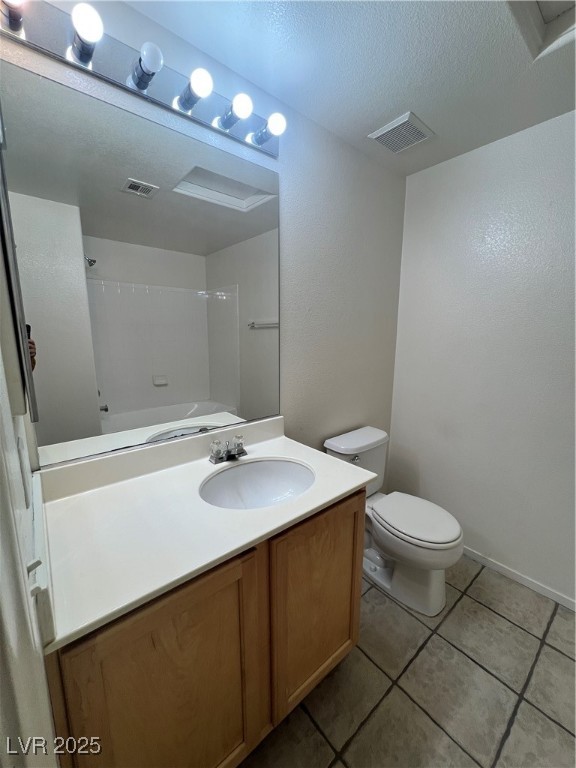 2152 Quarry Ridge Street, Unit 103 Las Vegas, NV 89117 - Photo 8 of 43 Full bathroom with vanity, light tile patterned flooring, washtub / shower combination, and a textured ceiling