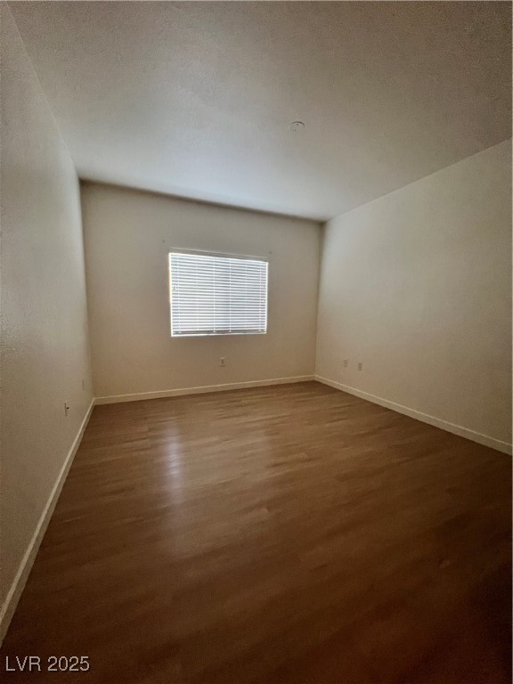 2152 Quarry Ridge Street, Unit 103 Las Vegas, NV 89117 - Photo 9 of 43 Spare room with dark wood-style floors and a textured ceiling
