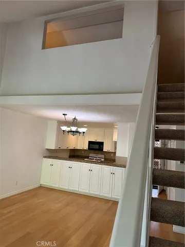a kitchen with granite countertop a sink and cabinets