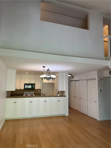 a kitchen with granite countertop a sink and cabinets