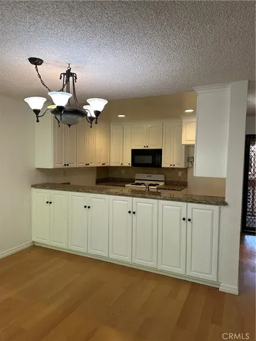 a kitchen with cabinets a sink and appliances