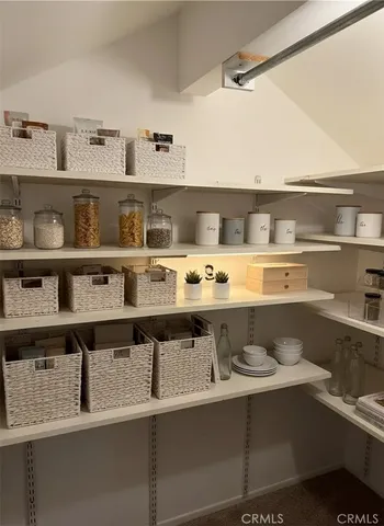 a view of a kitchen with stainless steel appliances a stove and cabinets