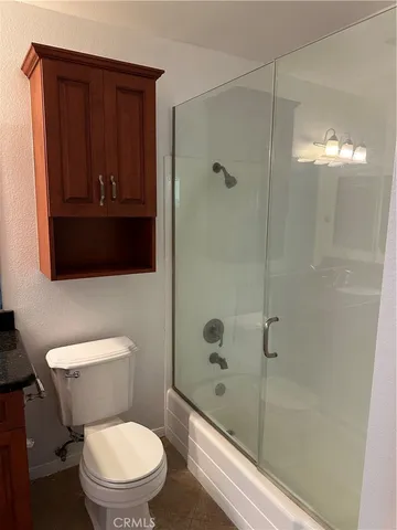 a bathroom with a toilet a sink and shower