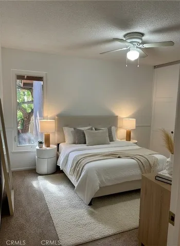 a spacious bedroom with a bed and window