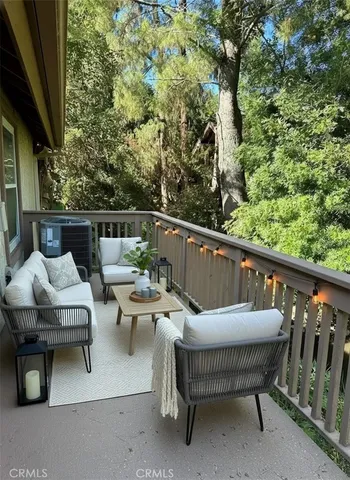 a balcony with wooden benches and a couch