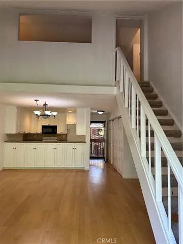 a kitchen with furniture and a large window
