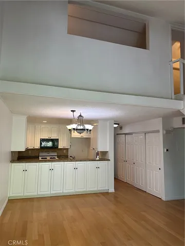 a kitchen with granite countertop a sink and cabinets