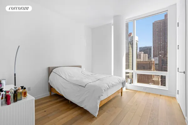 a bed sitting in a bedroom next to a window