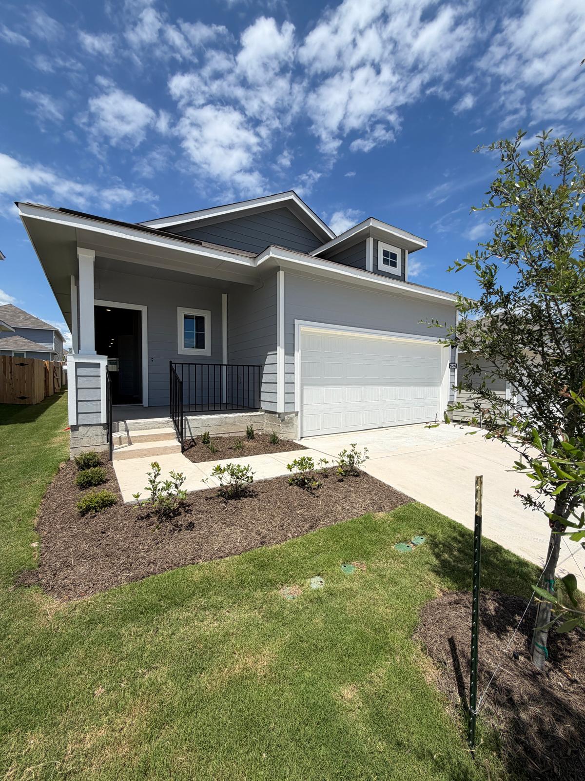 2612 Towy Road Manor, TX 78653 - Photo 2 of 35 A well-maintained facade with neat landscaping and a generous two-car garage awaits.