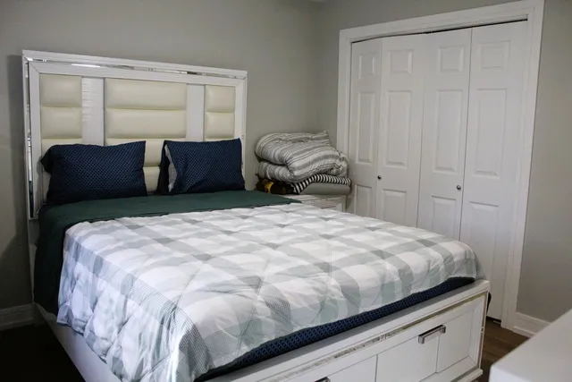 a bedroom with a bed and a window