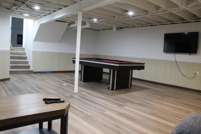 a room with wooden floor and furniture