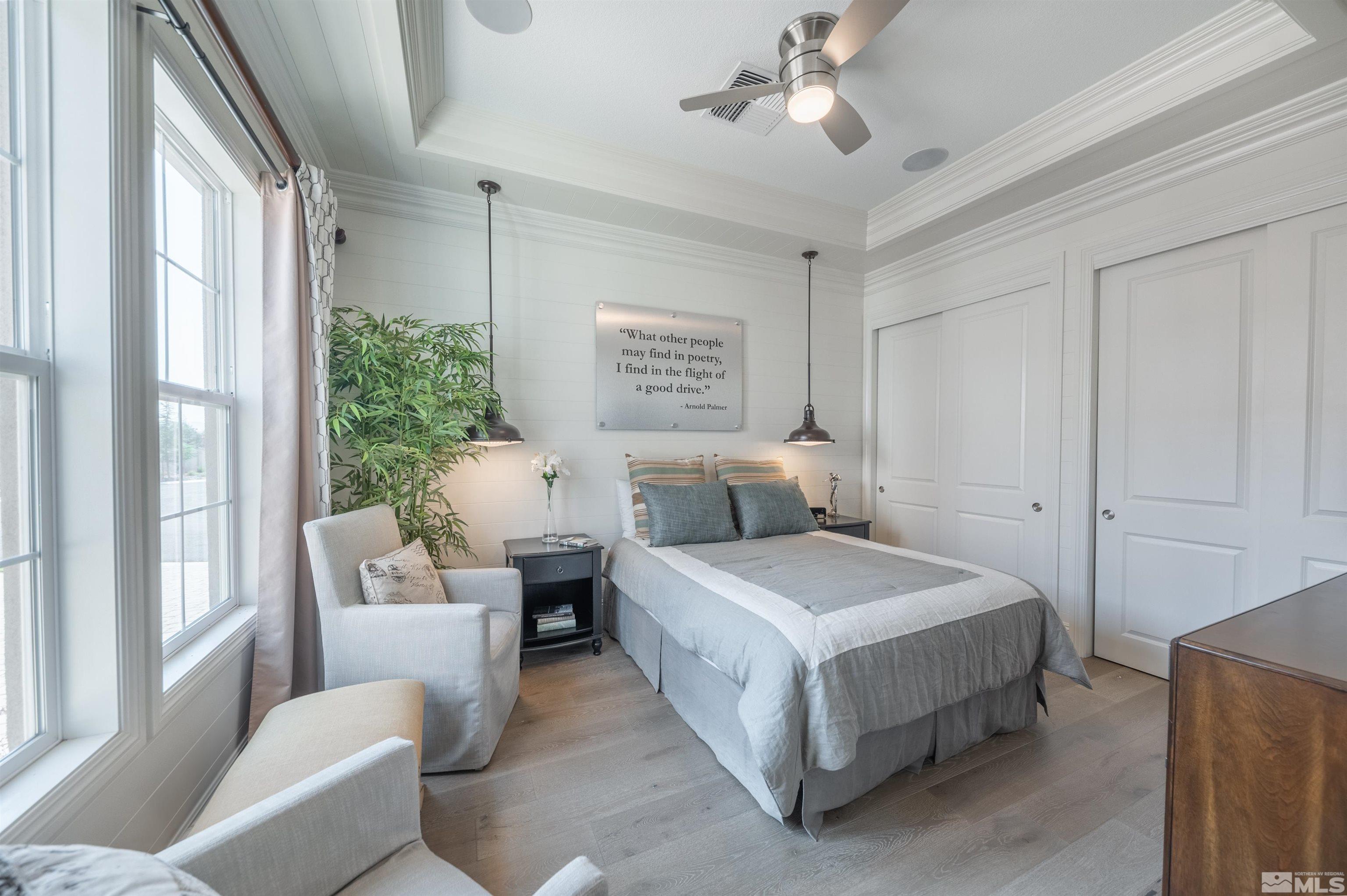 9990 Hafflinger Court Reno, NV 89521 - Photo 31 of 40 a spacious bedroom with a bed and a chandelier