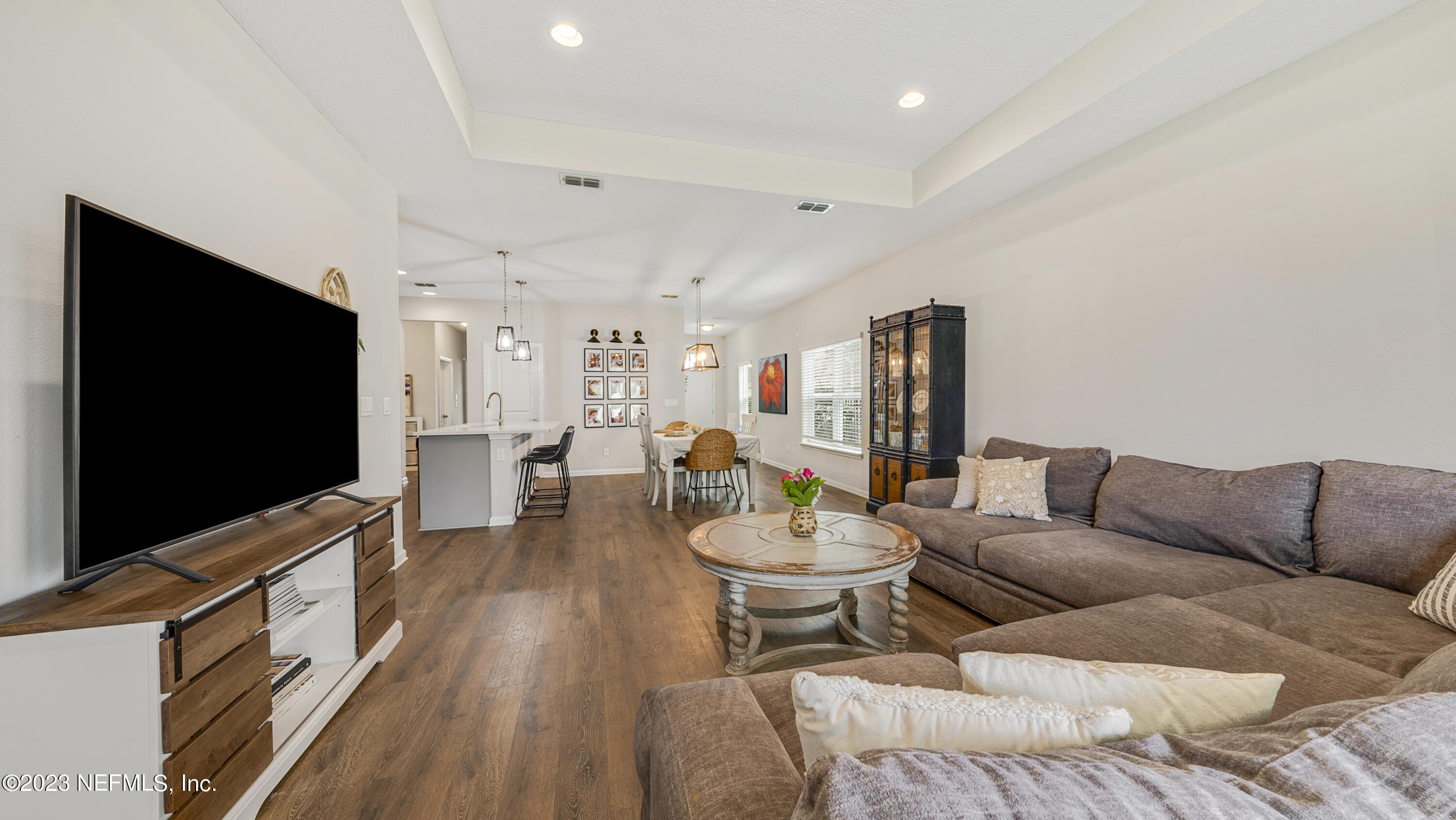 321 Beale Avenue St. Augustine, FL 32092 - Photo 17 of 35 a living room with furniture a flat screen tv and kitchen view