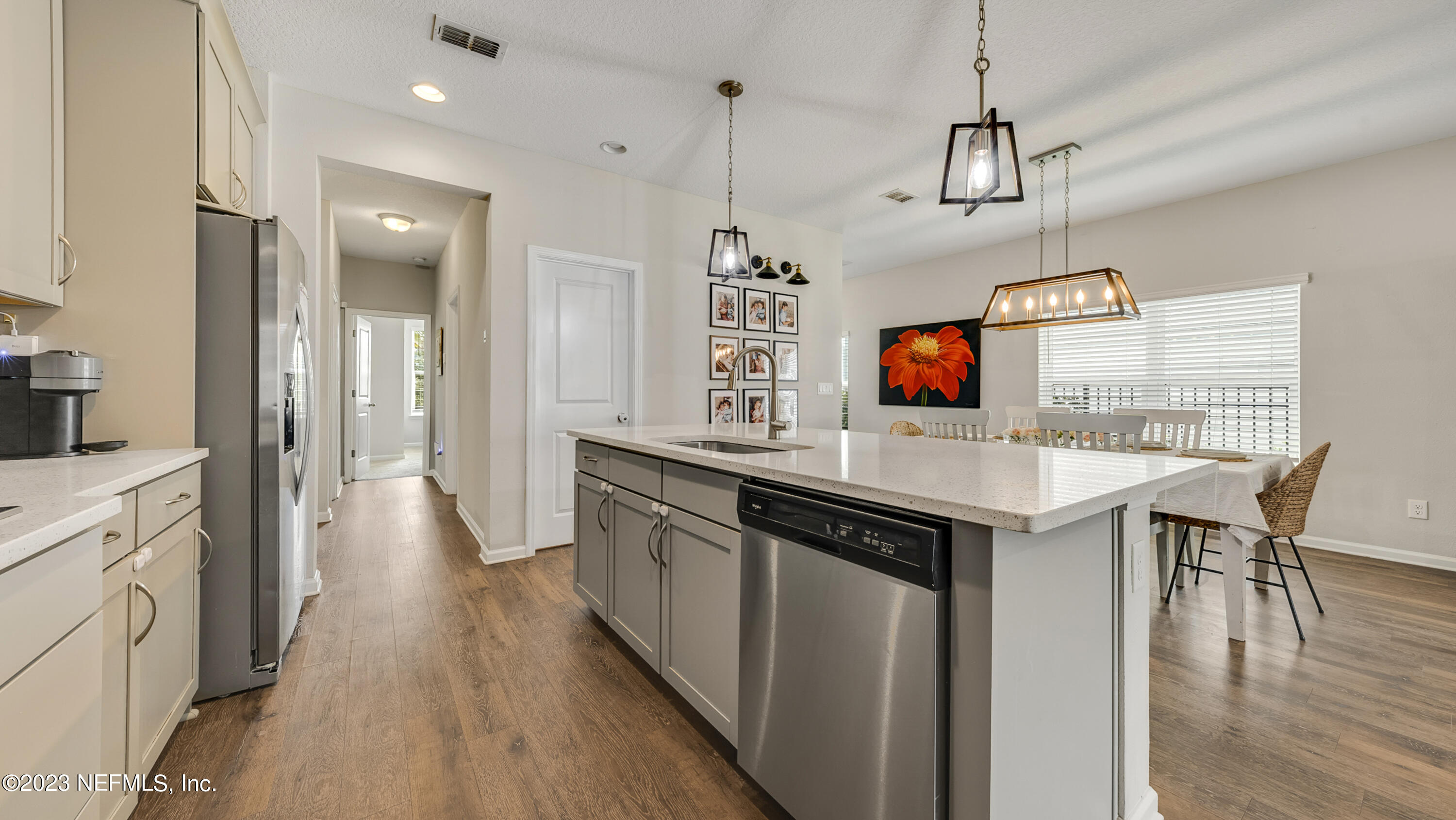 321 Beale Avenue St. Augustine, FL 32092 - Photo 3 of 35 a kitchen with stainless steel appliances granite countertop a sink a stove a refrigerator and island with wooden floor