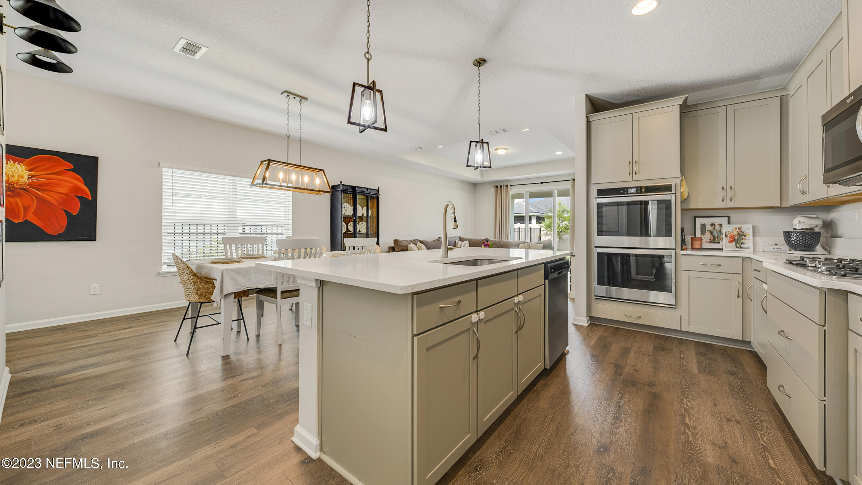 321 Beale Avenue St. Augustine, FL 32092 - Photo 4 of 35 a kitchen with stainless steel appliances granite countertop a stove oven a kitchen island a stove and a wooden floors