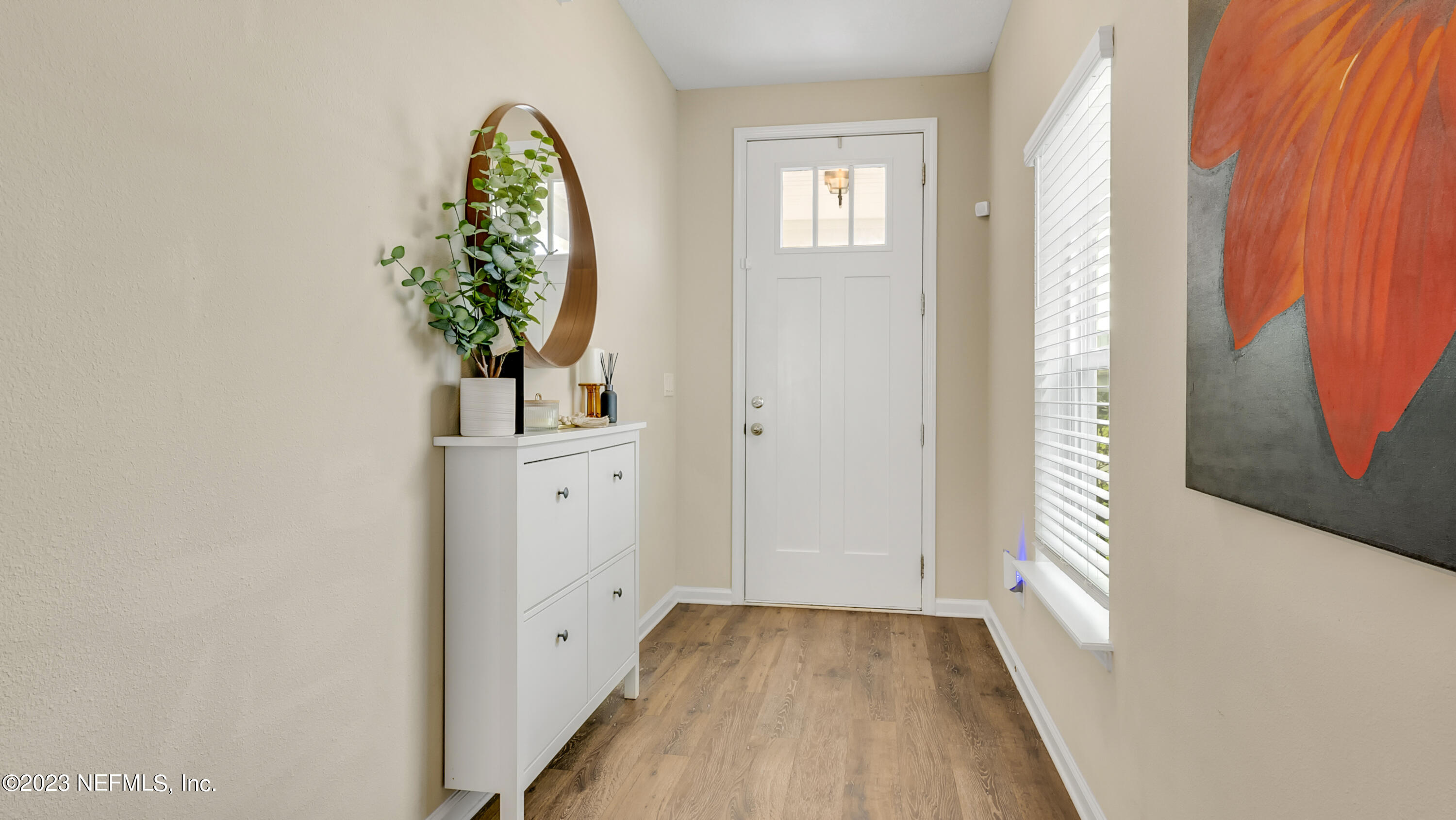 321 Beale Avenue St. Augustine, FL 32092 - Photo 5 of 35 a view of a hallway with wooden floor and a potted plant