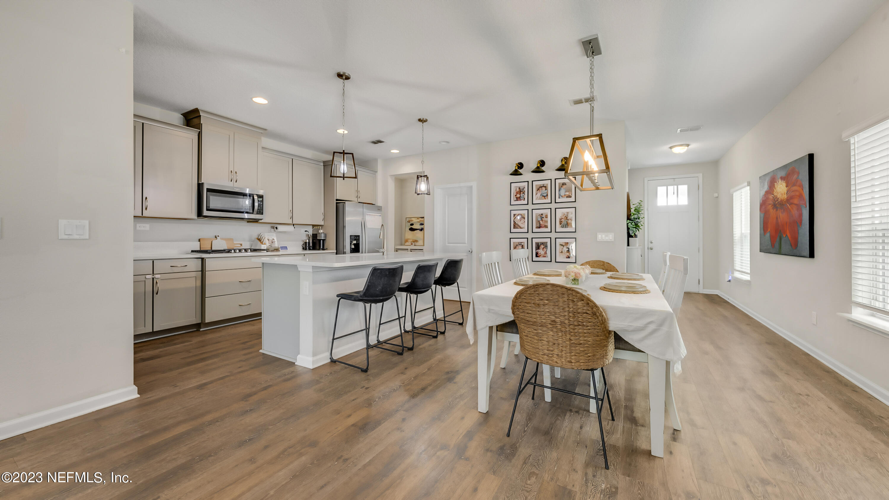 321 Beale Avenue St. Augustine, FL 32092 - Photo 8 of 35 a kitchen with stainless steel appliances granite countertop a stove top oven a sink a dining table and chairs with wooden floor