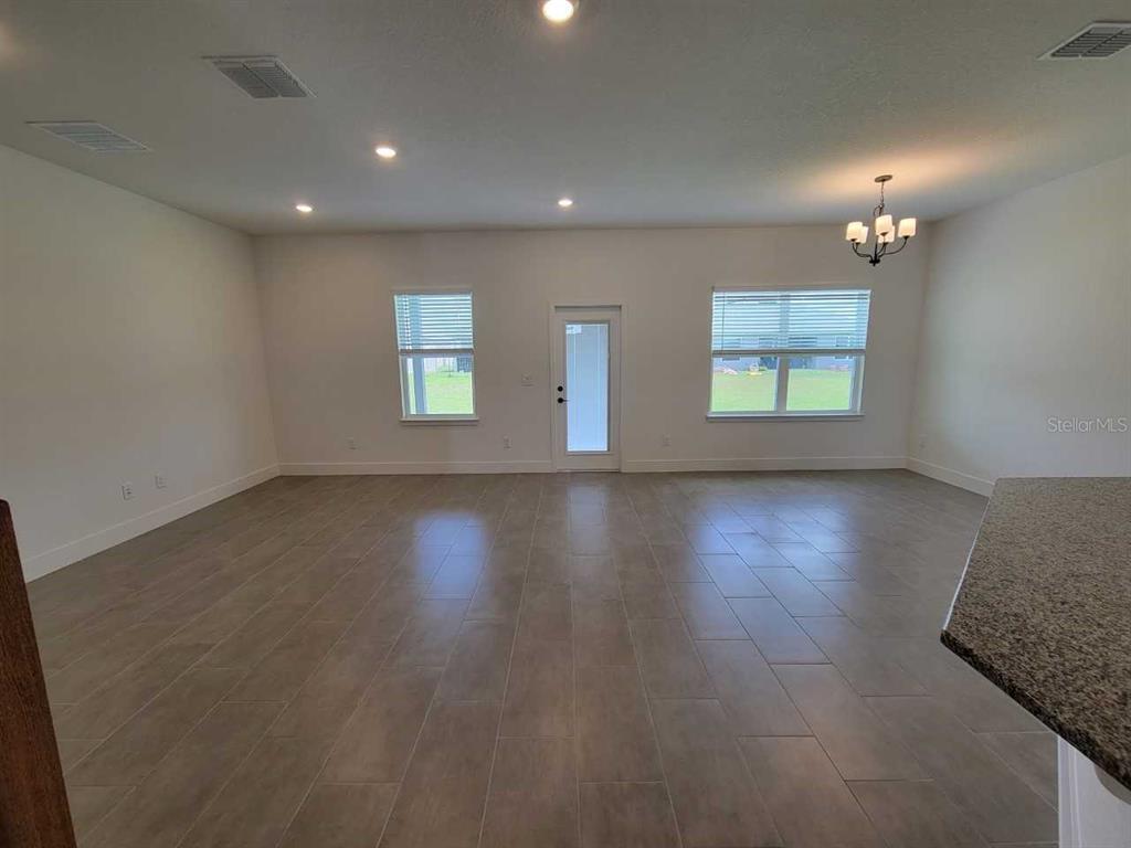 4380 Southwest 92nd Pl Road Ocala, FL 34476 - Photo 15 of 57 an empty room with wooden floor and windows
