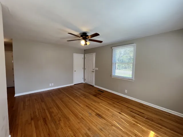 wooden floor in an empty room with a window