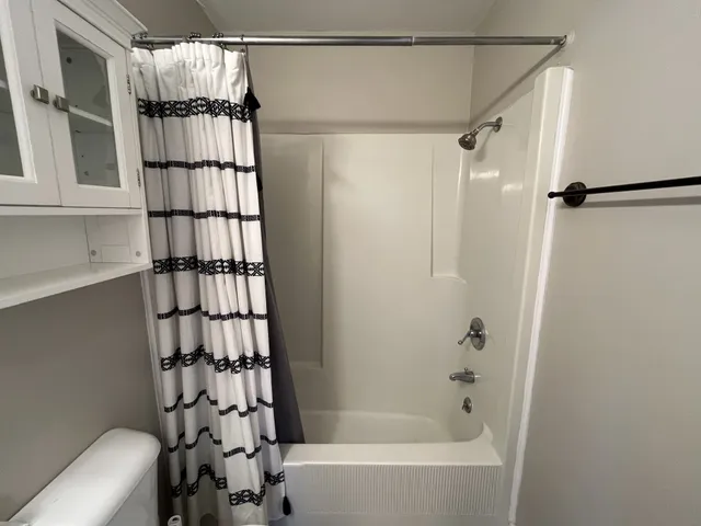 a bathroom with a bathtub and a shower