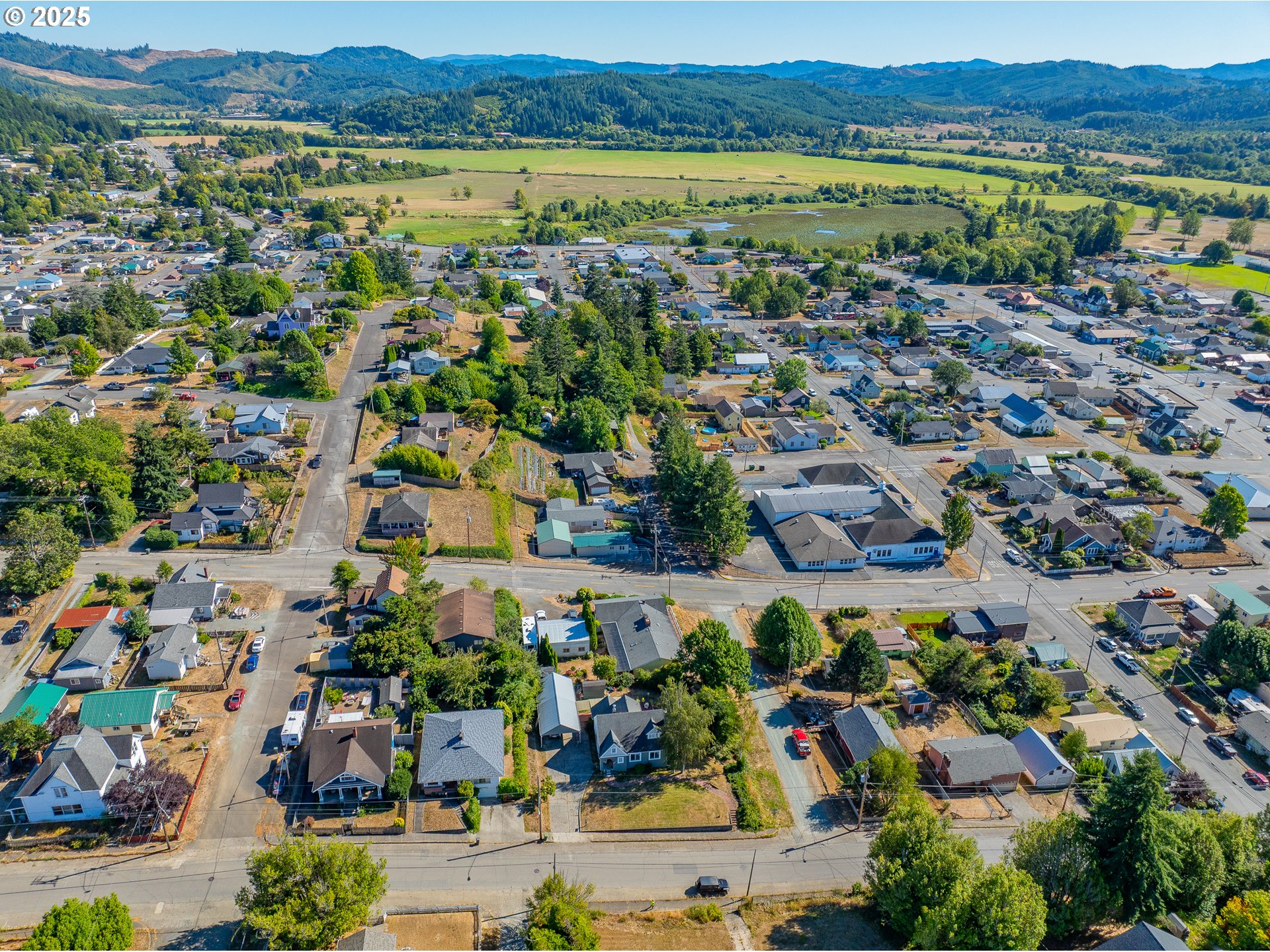 1112 Spruce Street Myrtle Point, OR 97458 - Photo 47 of 47 an aerial view of a city with lots of residential buildings and ocean view