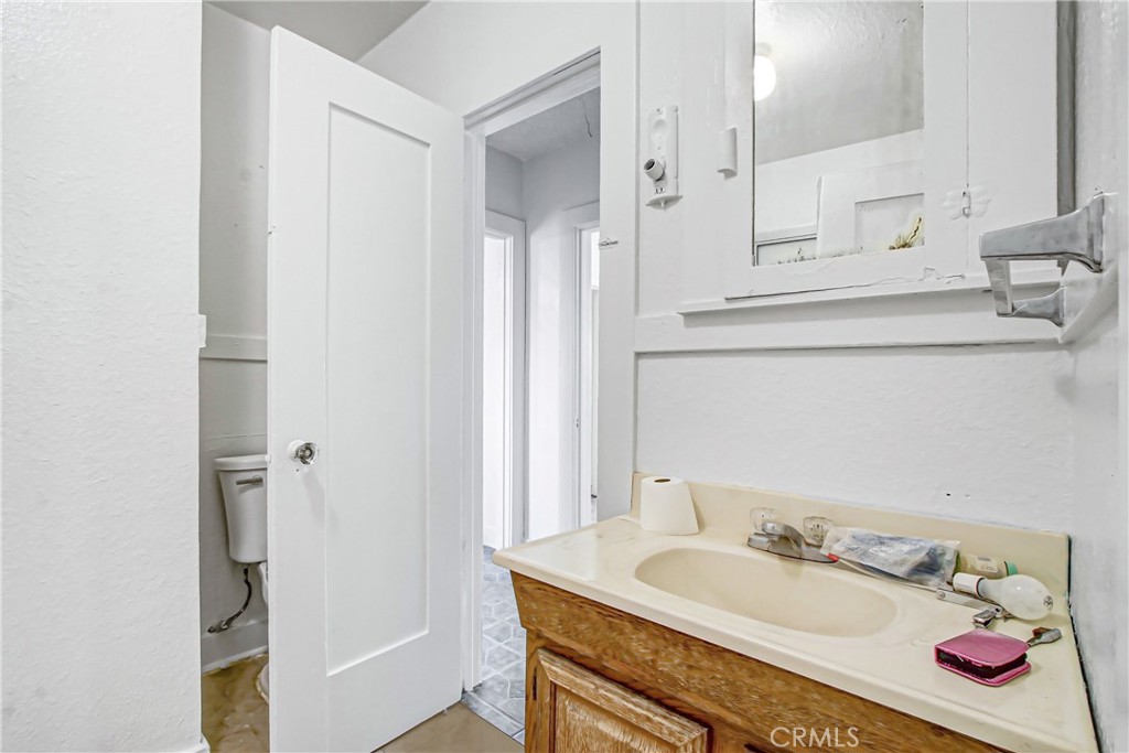 3463 Washington Street Riverside, CA 92504 - Photo 13 of 24 a bathroom with a granite countertop sink and a mirror