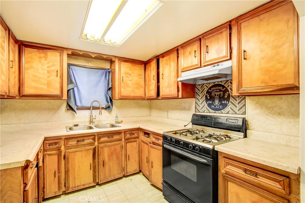 3463 Washington Street Riverside, CA 92504 - Photo 17 of 24 a kitchen with a sink stove top oven and cabinets
