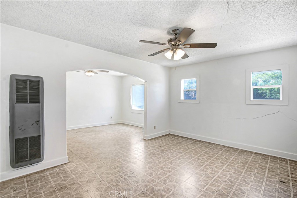 3463 Washington Street Riverside, CA 92504 - Photo 4 of 24 a view of an empty room with a ceiling fan