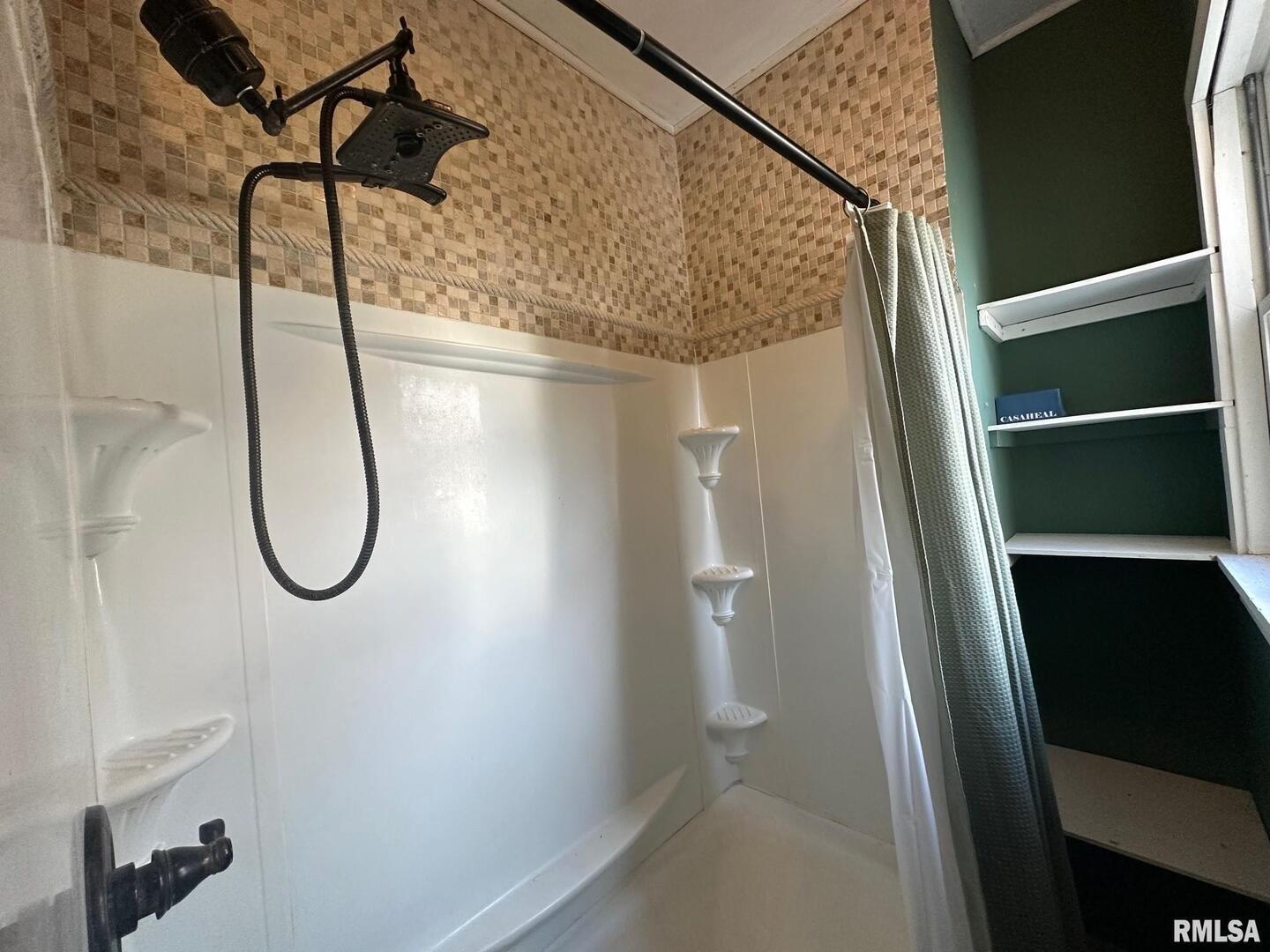 323 Lincoln Street Miles, IA 52064 - Photo 12 of 34 a bathroom with a glass shower door