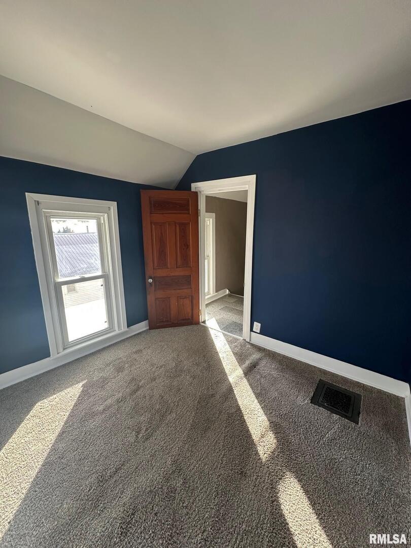 323 Lincoln Street Miles, IA 52064 - Photo 18 of 34 a view of an empty room and window and wooden floor