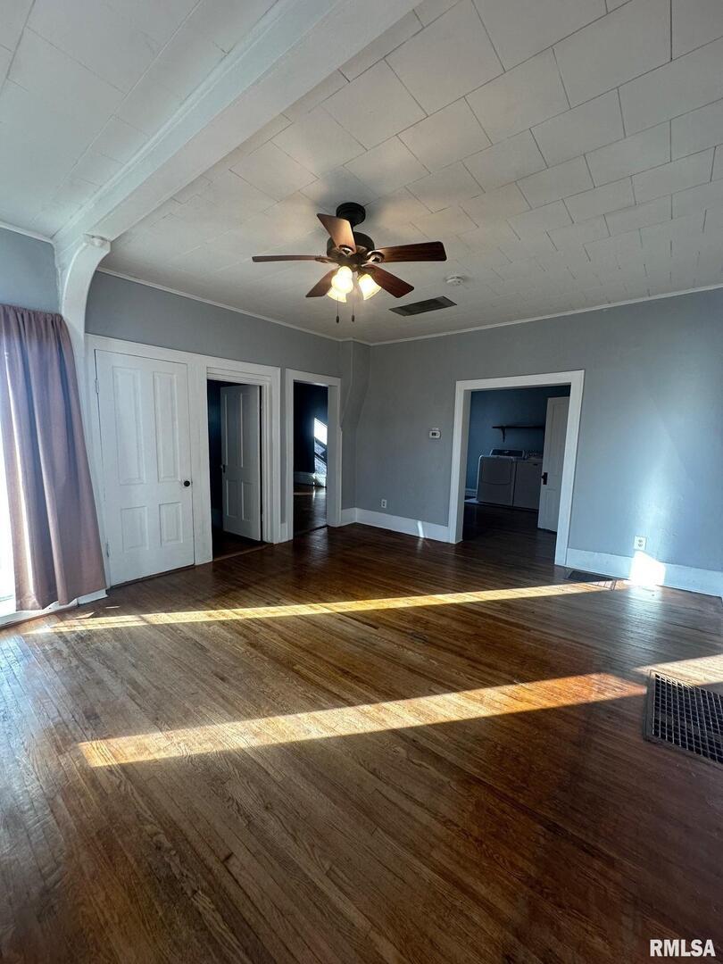 323 Lincoln Street Miles, IA 52064 - Photo 4 of 34 a view of empty room with wooden floor and fan