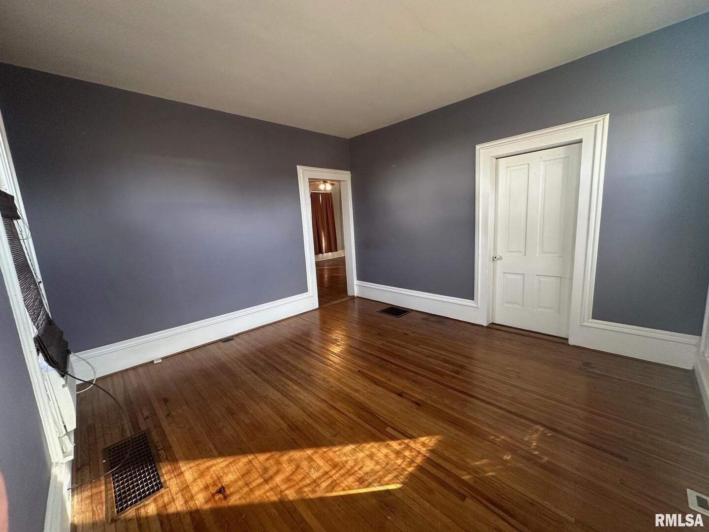 323 Lincoln Street Miles, IA 52064 - Photo 7 of 34 a view of an empty room and wooden floor