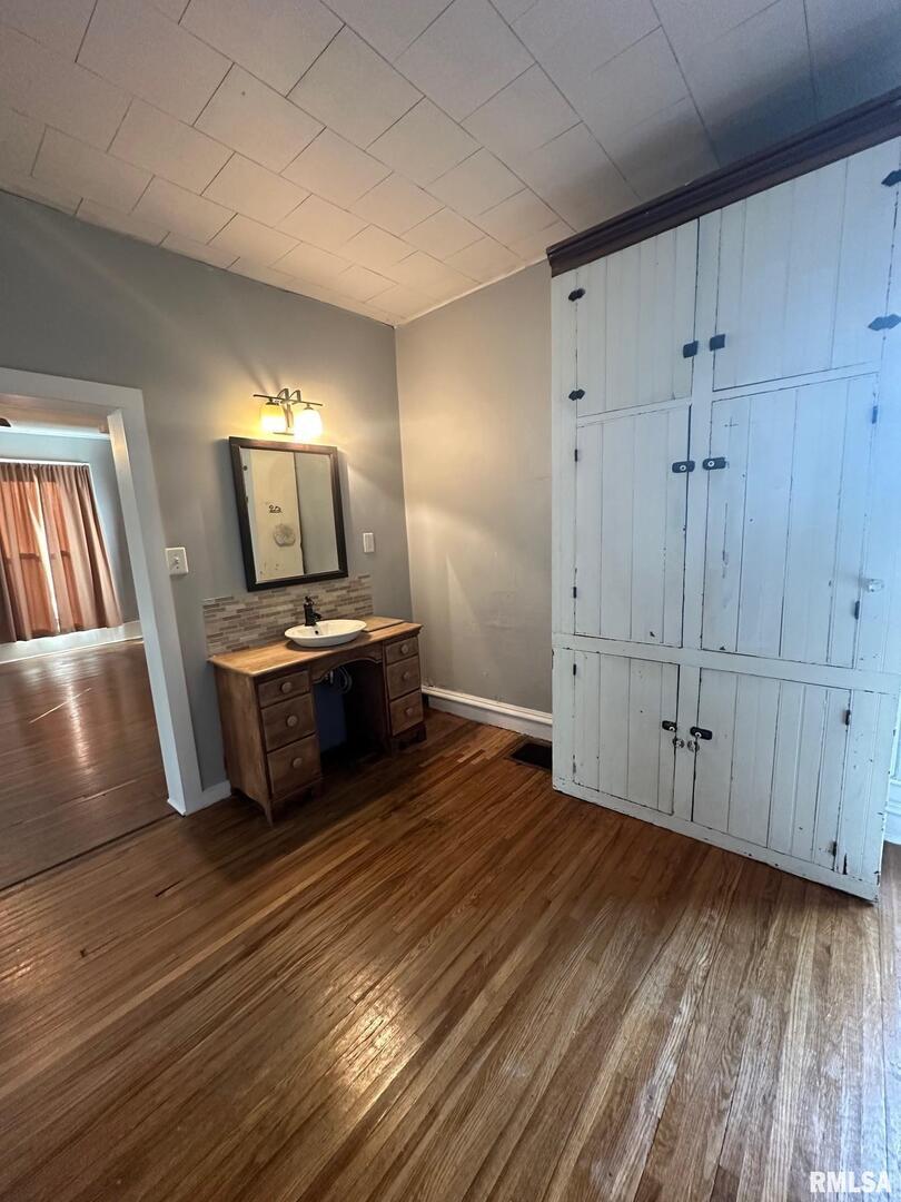 323 Lincoln Street Miles, IA 52064 - Photo 9 of 34 a view of a kitchen with wooden floor electronic appliances and furniture