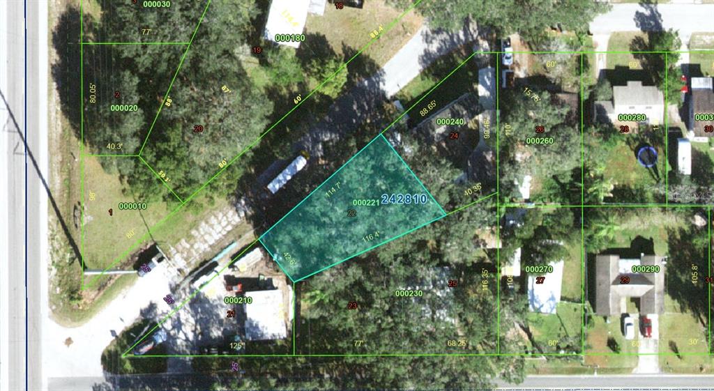 an aerial view of residential house with outdoor space and trees all around