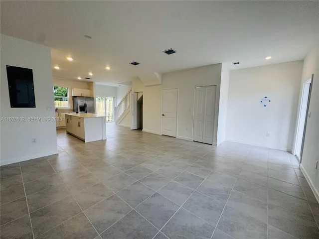 an empty room with windows and closet